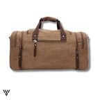 NomadVault Canvas Duffel Bag, men's outdoor travel bag in brown, detailed back side view - VAYOME.