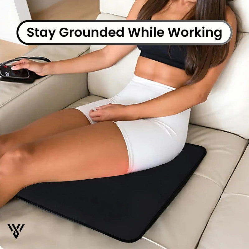 CoreBalance Grounding Mat, lifestyle image of a girl sitting on the mat on a sofa, promoting use for relaxation and relief - VAYOME.