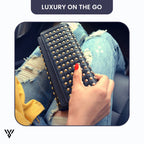 Woman model showing the elegant CovaRivet 3-Fold Leather Wallet in black inside a car - VAYOME.