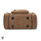 NomadVault Canvas Duffel Bag, men's outdoor travel bag in brown, durable bottom side view - VAYOME.