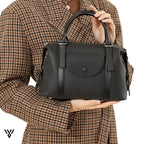 Versatile Contrast Leather Lock Bag for women, a model holding the stylish shoulder/handbag in Black color - VAYOME.